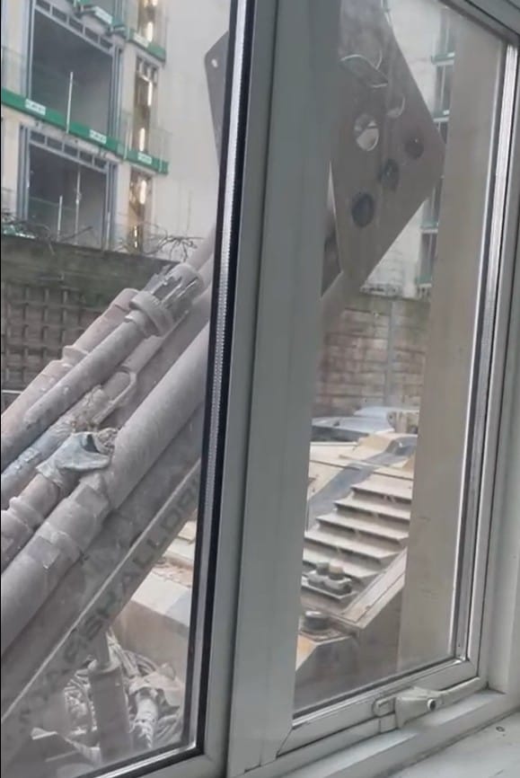 Heavy equipment propped outside resident's window