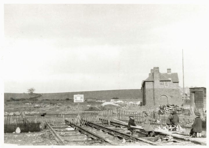 Open fields and children playing on unused railway tracks, Downham Estate 1926