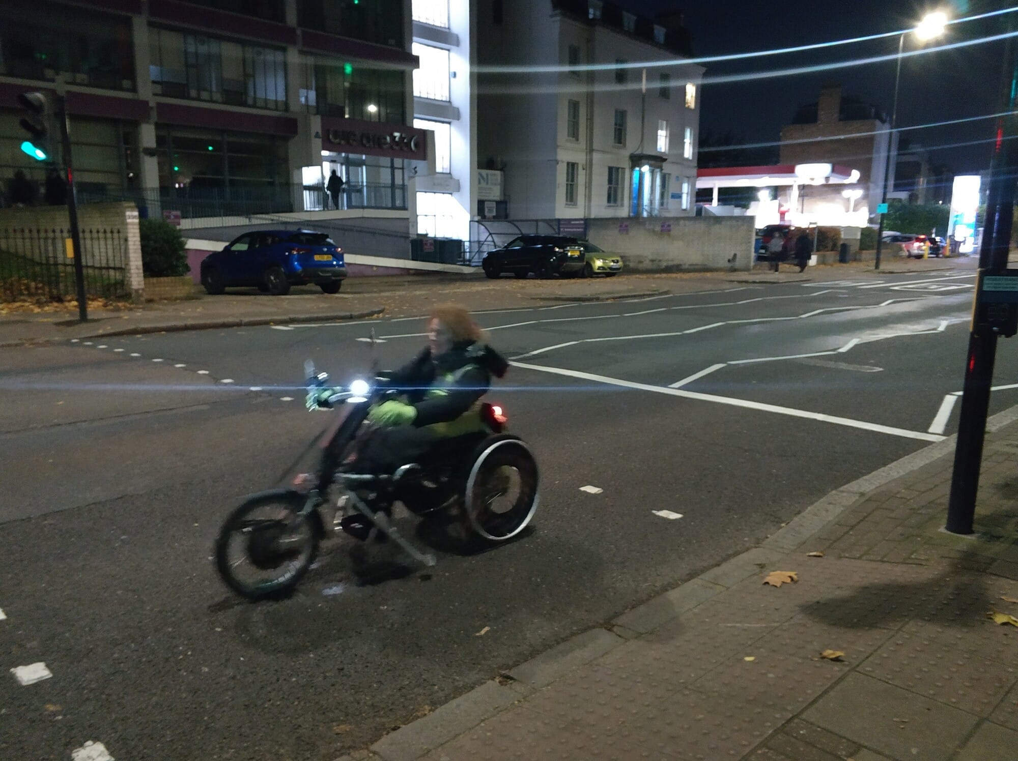 Handcycling an e-assist bike after dark.