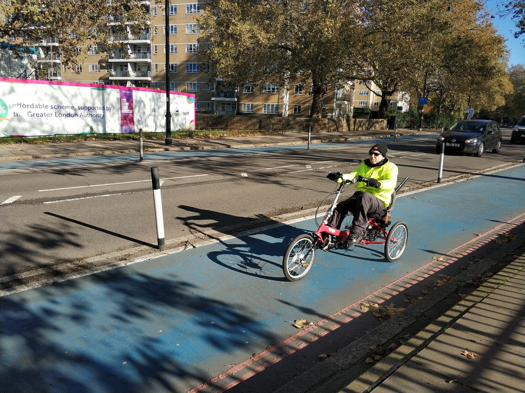 Recumbent e-assist trike in protected lane.