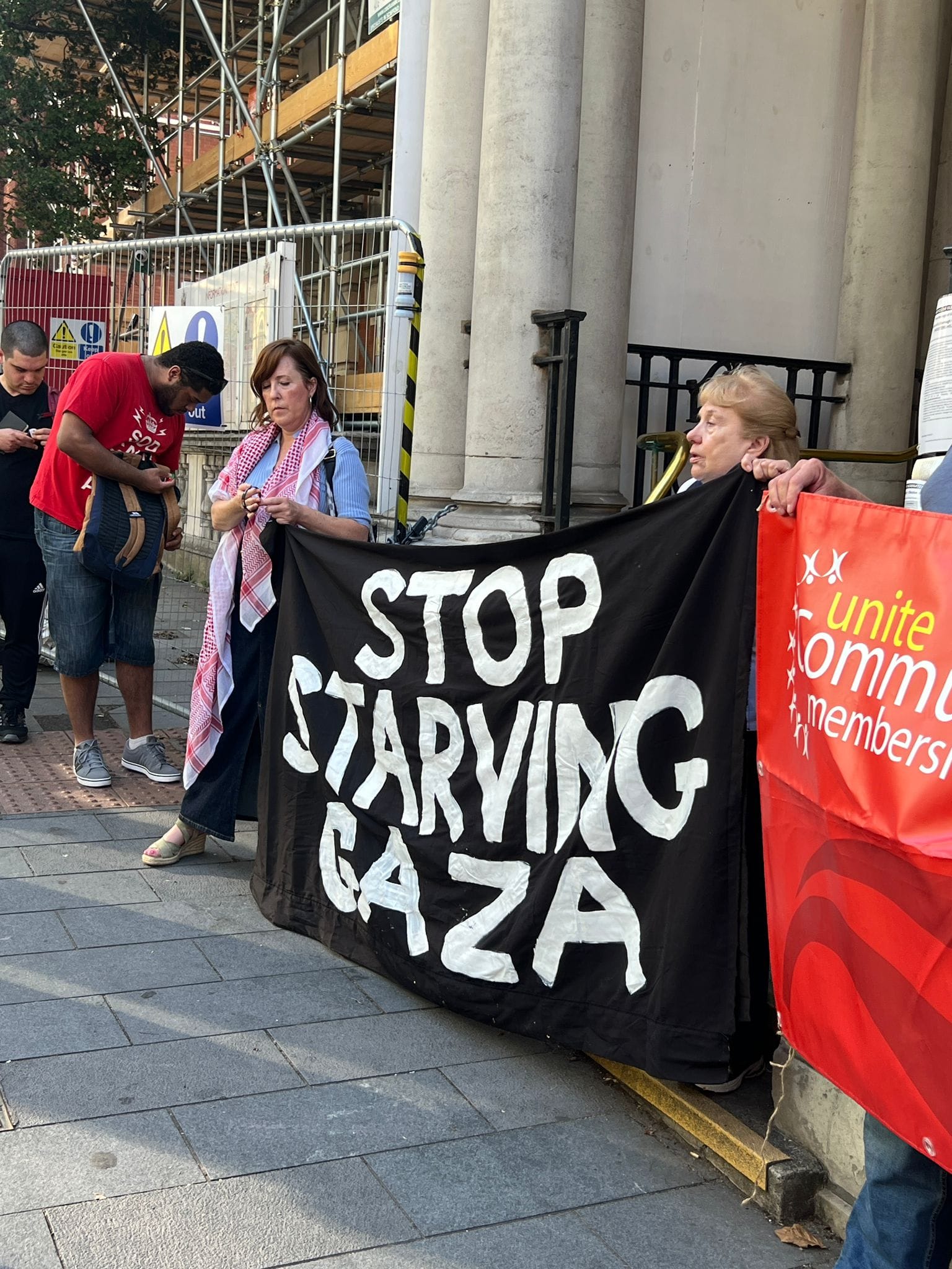 Protestors outside Greenwich town hall with banner "Stop Starving Gaza".