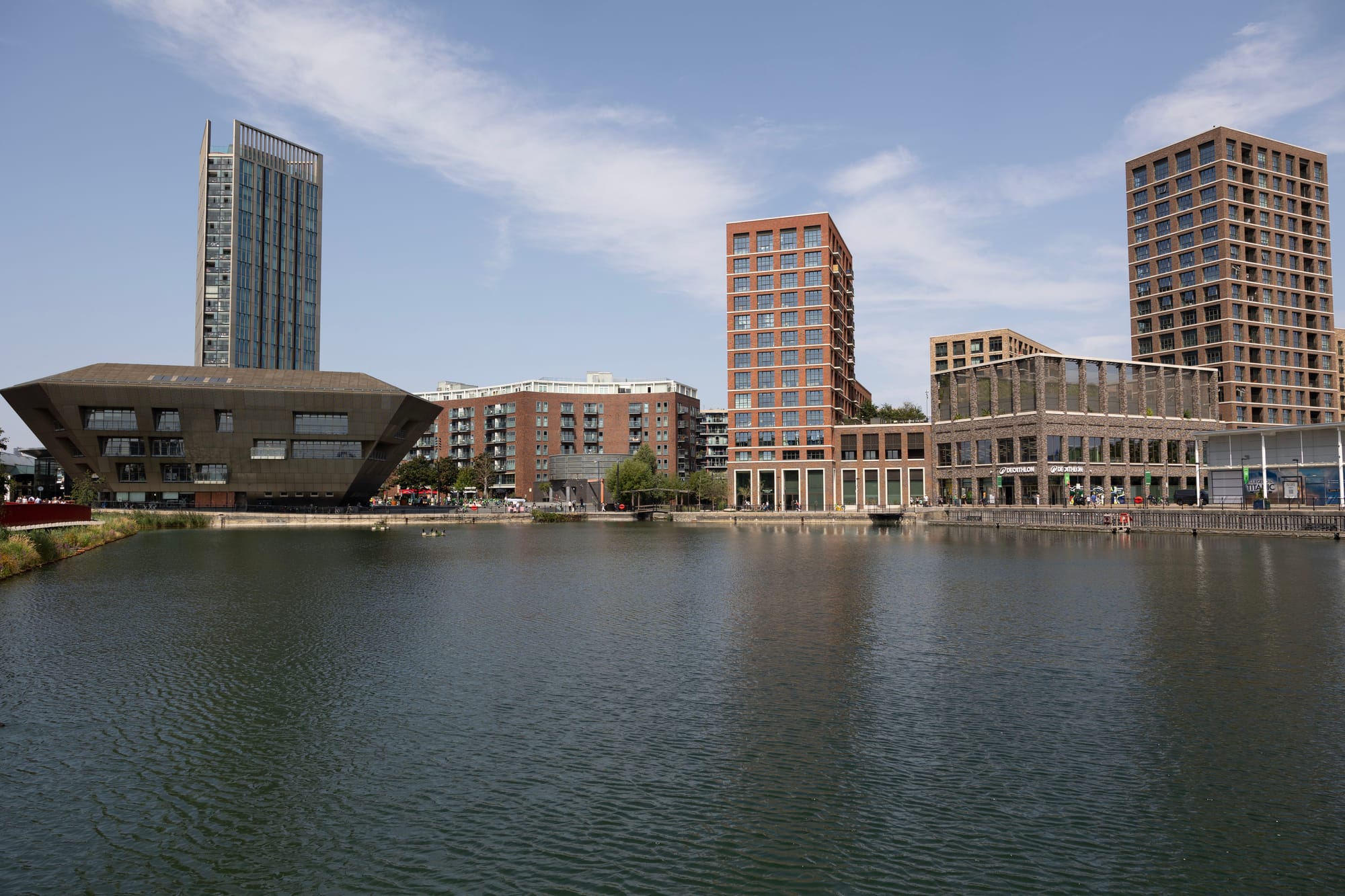Phase 1: 3 tower blocks and hectagonal leisure centre seen across water