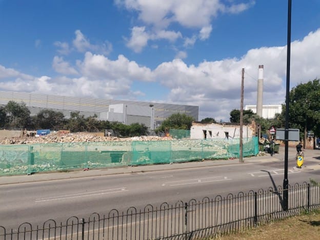 Construction site close to SELCHP where new housing development starting, June 2022. Chimney visible.