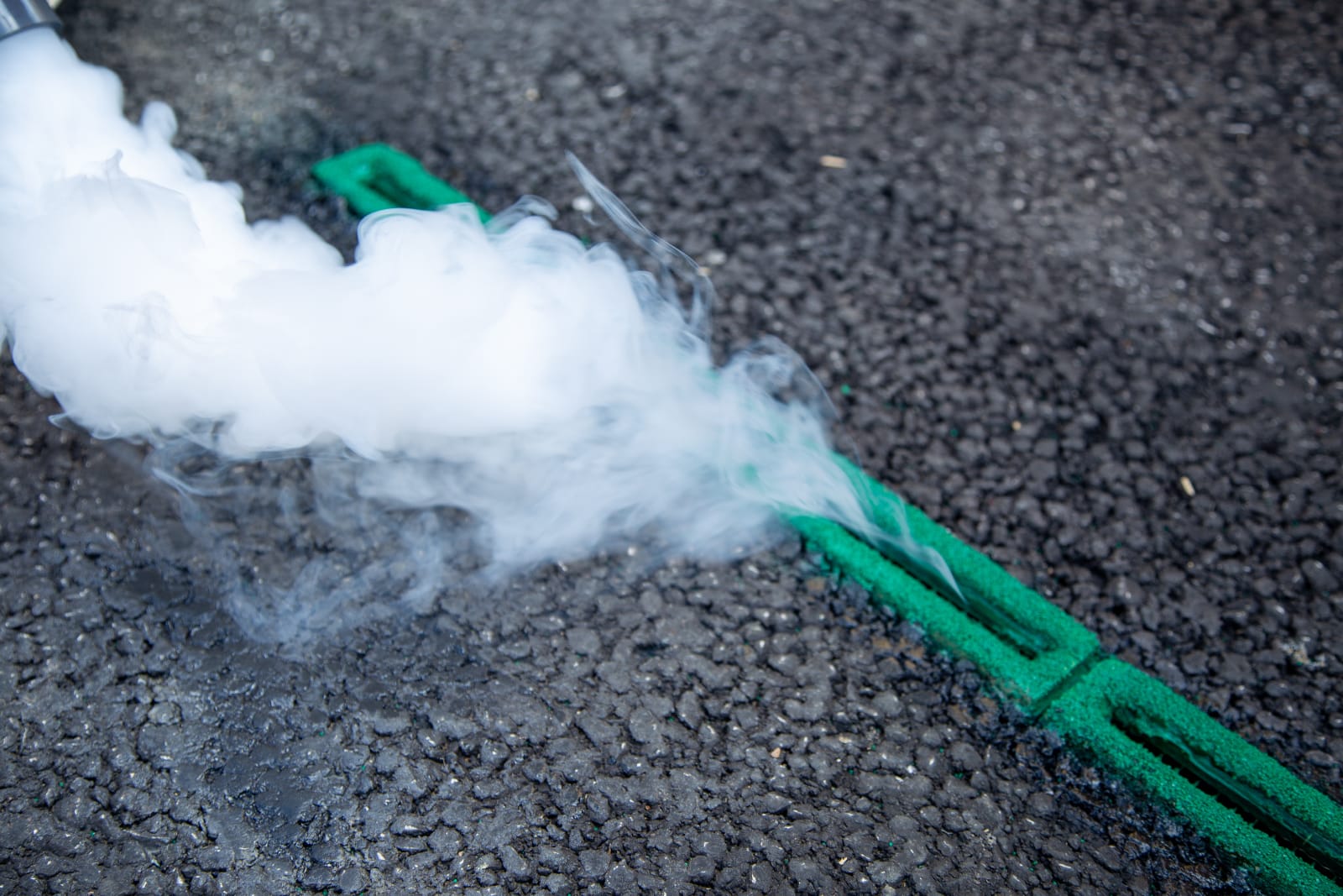 Smoke being sucked into channels in road surface
