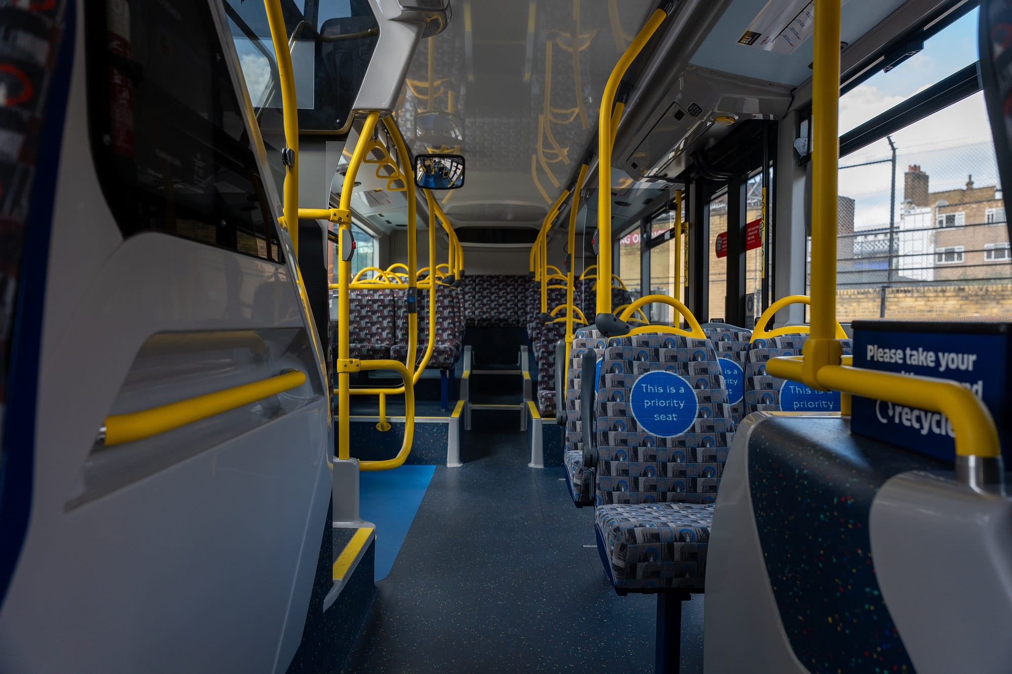 Interior of bus showing new moquette for priority seats with words "This is a priority seat". 