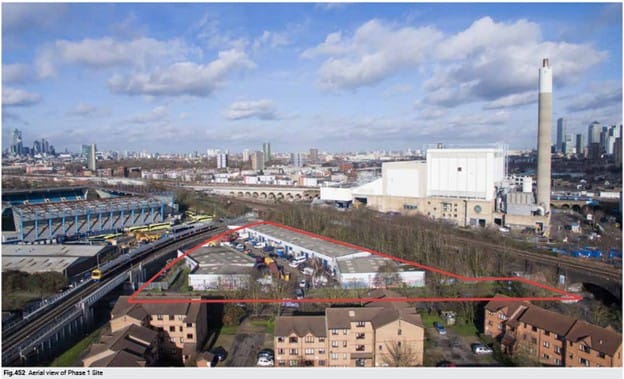 Aerial view of the triangular phase 1 site, with SELCHP incinerator chimney on other side of train track.