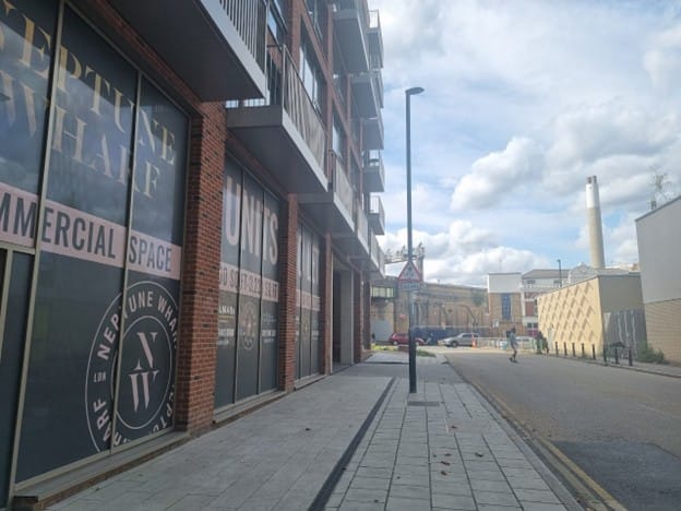 Empty commercial units at Neptune Wharf with signs advertising "commercial units to let".