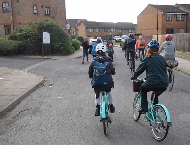 These two pals had matching teal bikes, and were able to ride side-by-side and chat with each other. On the right, Jane, or “Dr. Bike” from Lewisham cyclists, helps marshals. 