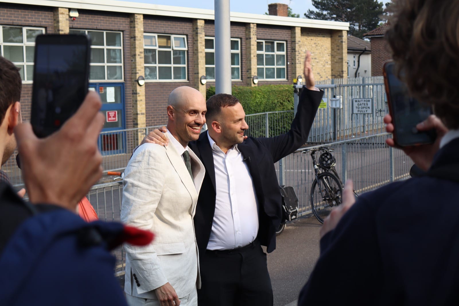 Liam Shrivastava and Zack Polanski outside the school.