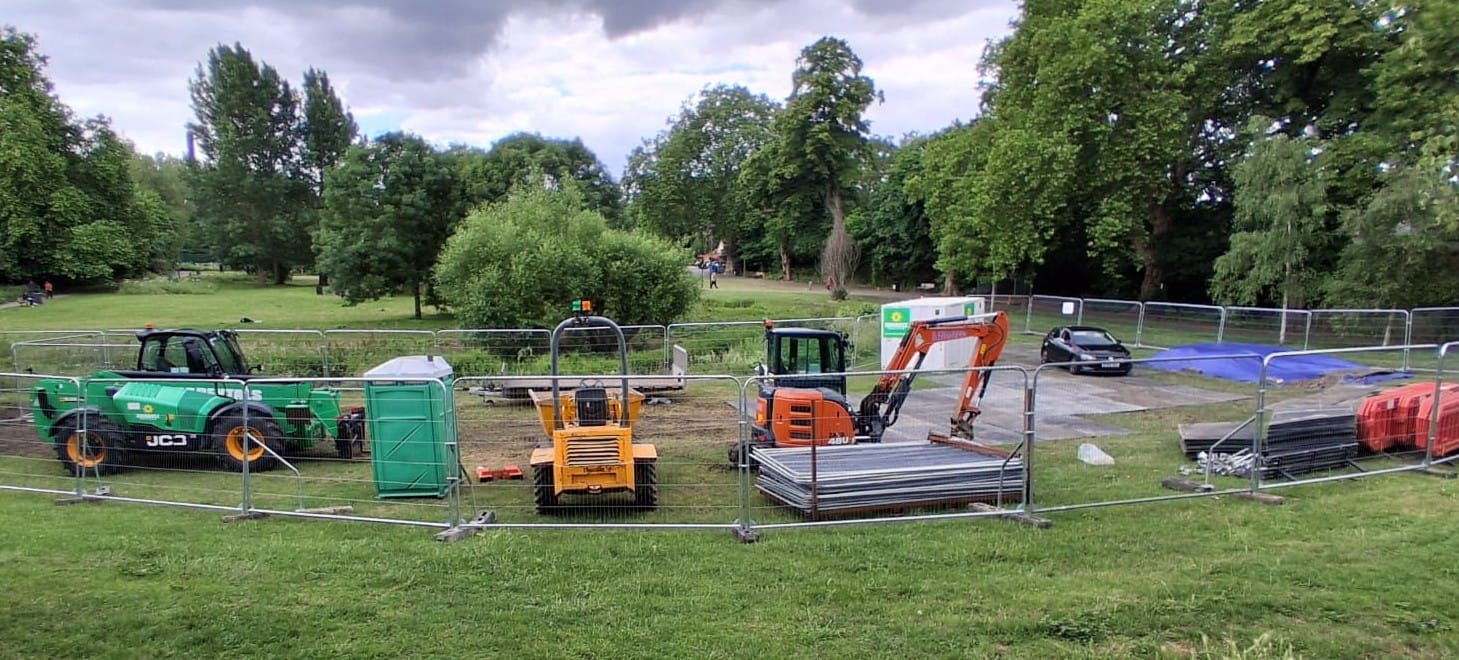 3 different diggers lined up behind fencing in the north field