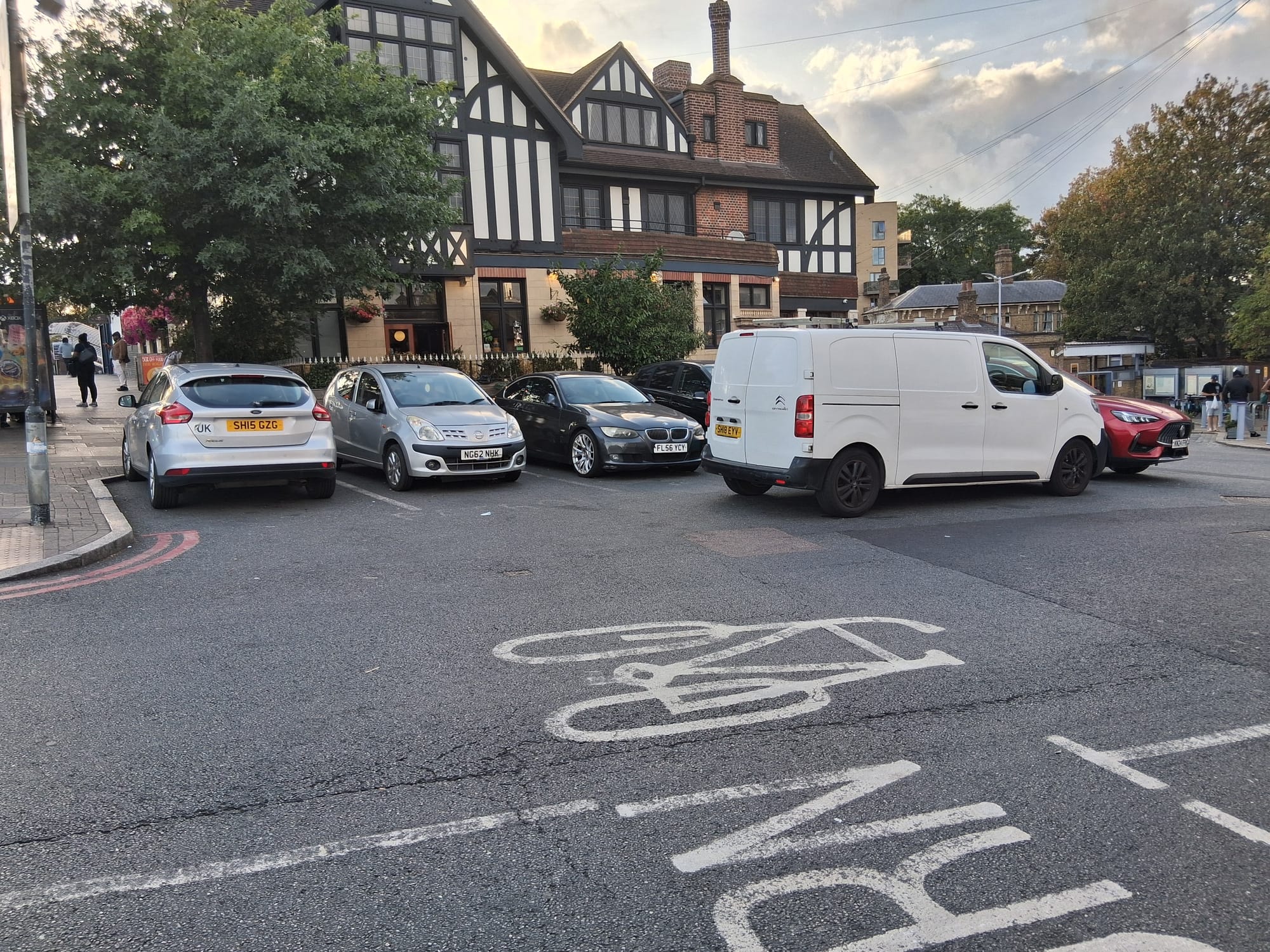 Cars and van parked outside Catford Bridge Tavern, Doggett road where yellow lines are planned.