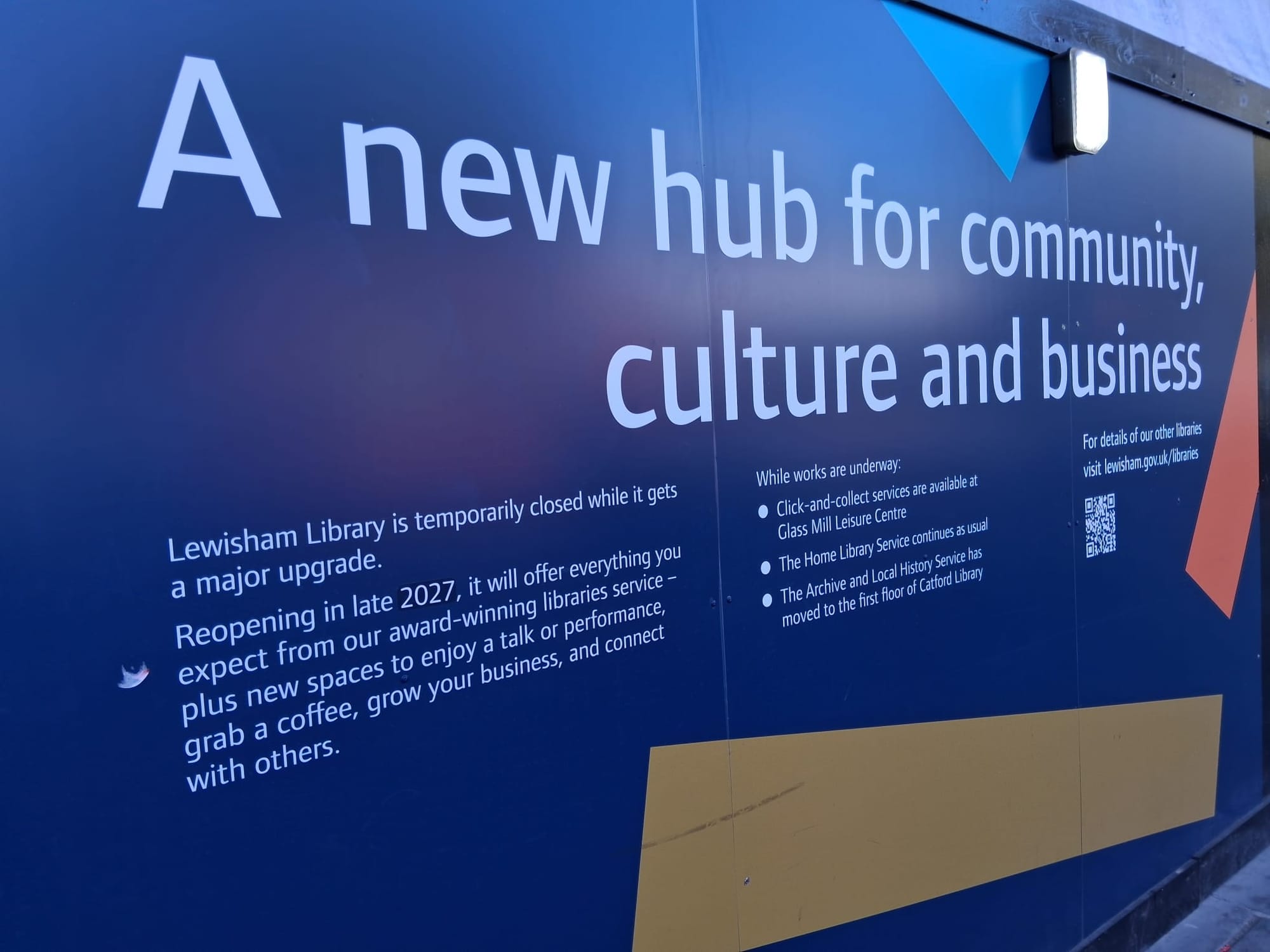 Billboard outside library, "A new hub for community, culture and business".