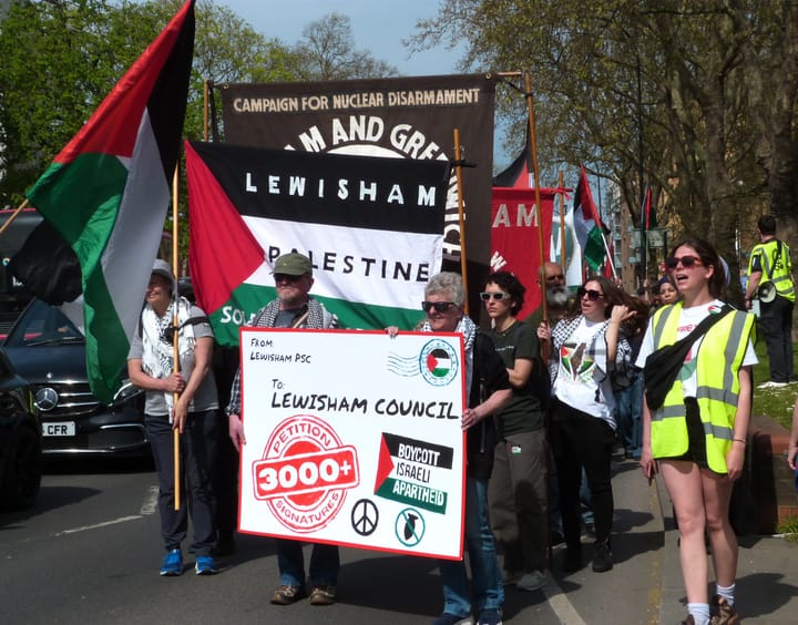 Campaigners marching with giant envelope stamped "petition 3000+ signatures"