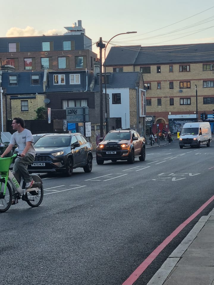 Cyclist negotiates the dangerous Amersham Gyratory, New Cross. 