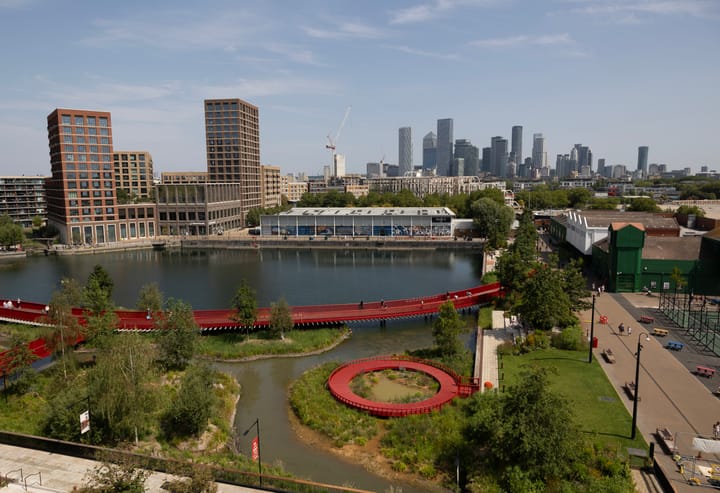 Phase 1 development seen from south including Rafter Walk - a red curved boardwalk over water. 