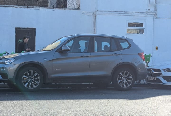 Large SUV parked at roadside.