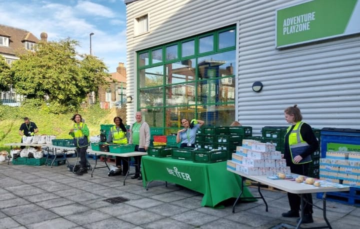 Volunteers at tables outside Bellingham Leisure Centre stacked with crates and boxes of produce.