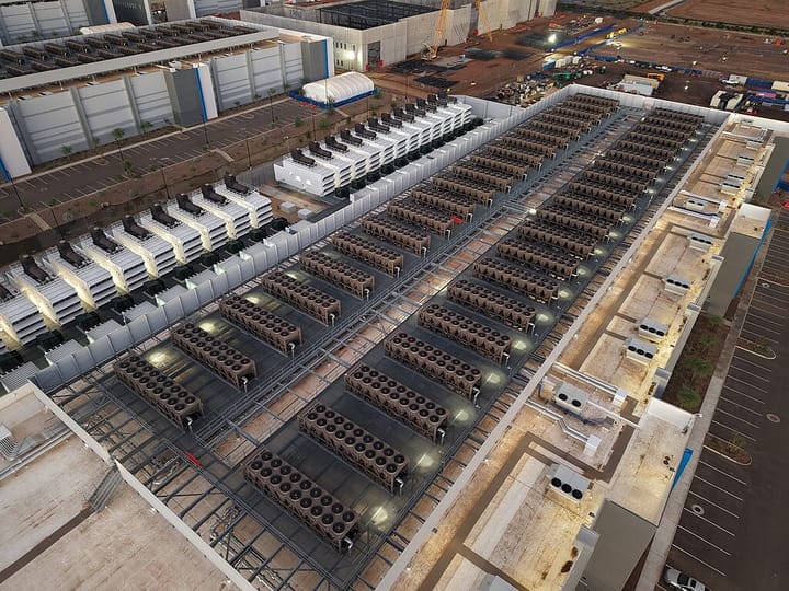 Roof of data centre showing long rows of cooling towers and backup generators, Arizona.