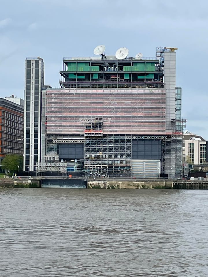 Telehouse data centre under construction, scaffolding visible, at Canary Wharf.  Seen from across Thames.