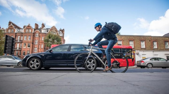 Cyclist on busy road, Hammersmith and Fulham