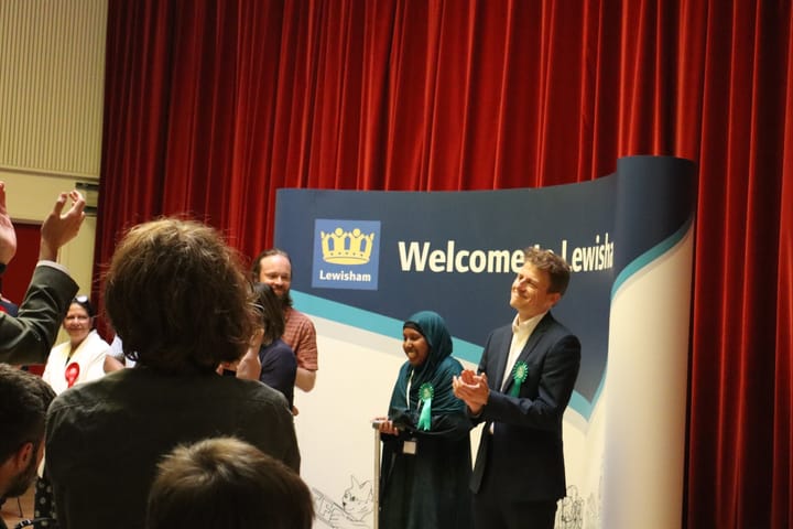 Newly elected Green councillors clap for other results