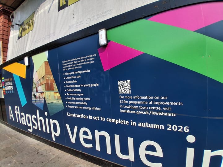 Billboards outside library with the words "A flagship venue .. construction is set to complete in autumn 2026".