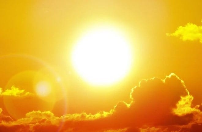 Blazing yellow sun and some clouds. 