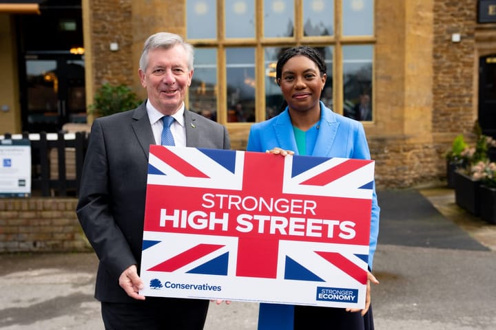 Bromley council leader Colin Smith and Conservative leader Kemi Bandenoch smiling holding union jack sign "Stronger High Streets"